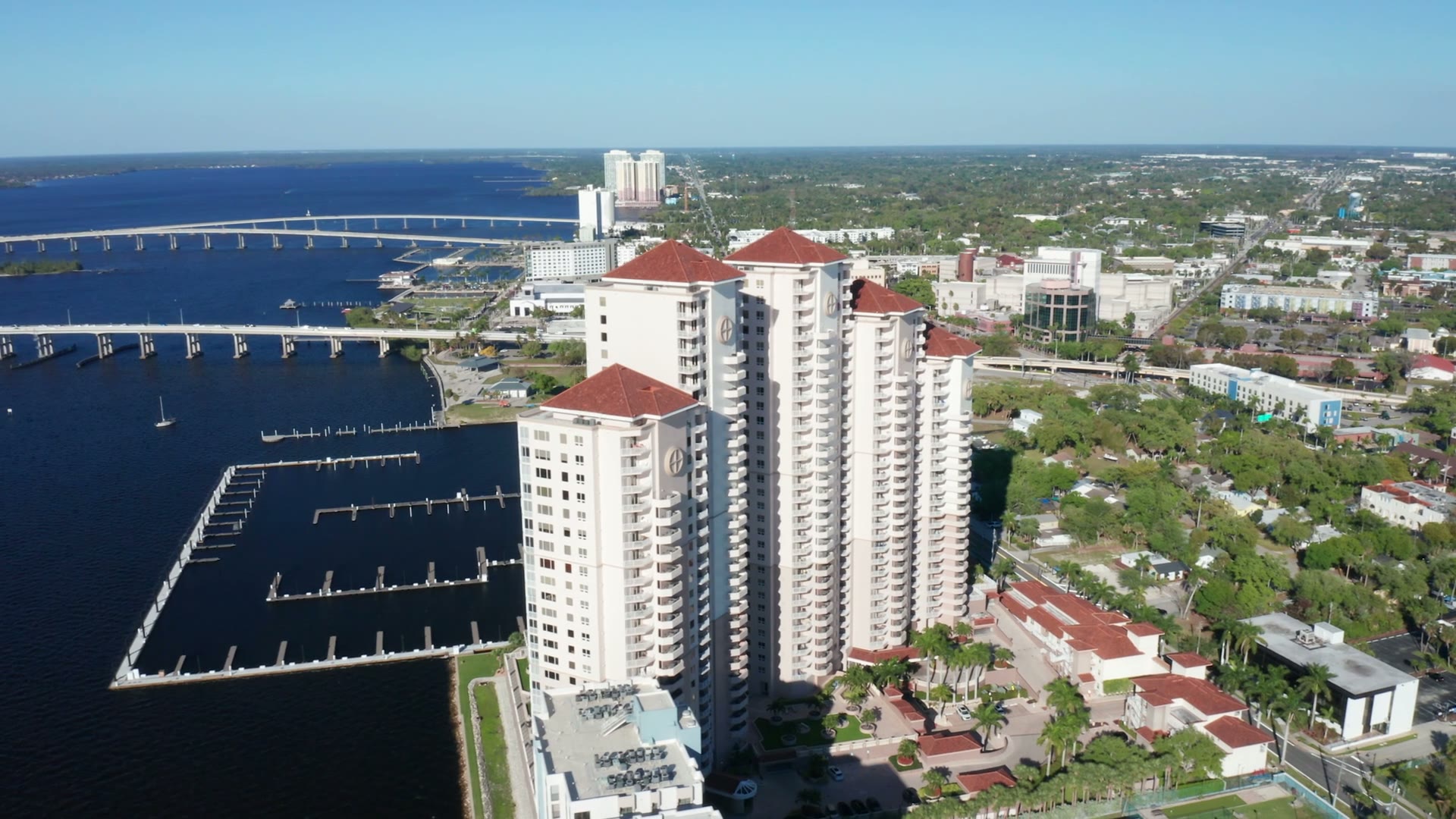 Aerial view of high-rise condos and a marina on the Caloosahatchee River in Fort Myers
